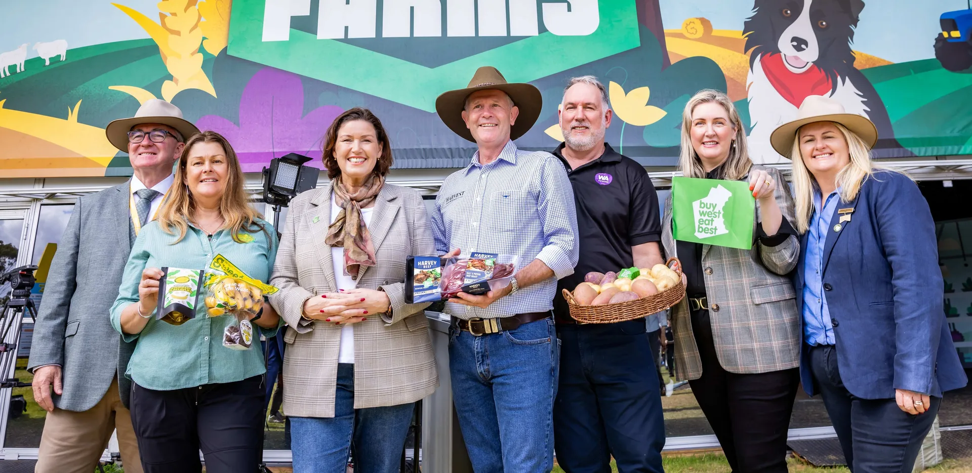 Group of people standing in front of a “Smart Farms” display at an agricultural event