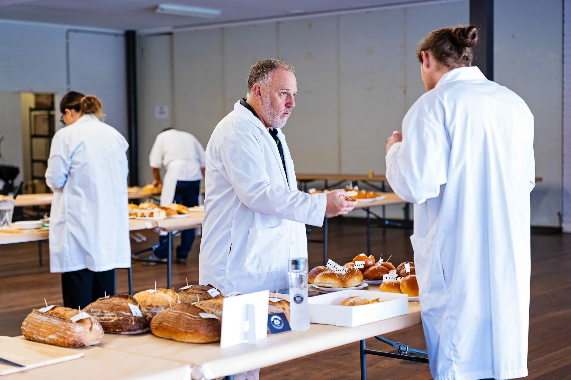Judges assessing baked goods at the Perth Royal Food Awards, evaluating quality, flavour, and presentation.