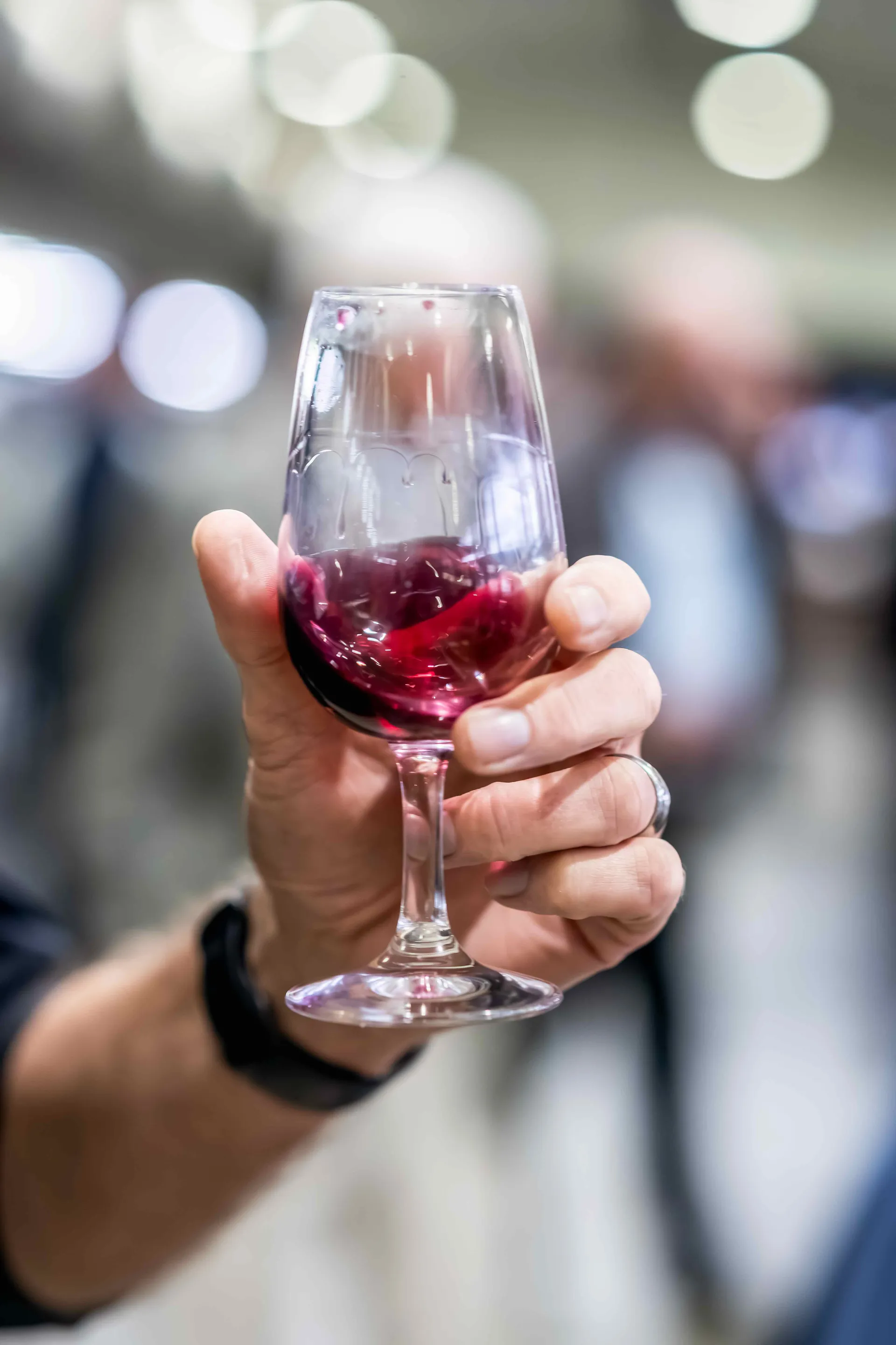 Judge swirling a red wine sample at the Perth Royal Food Awards.