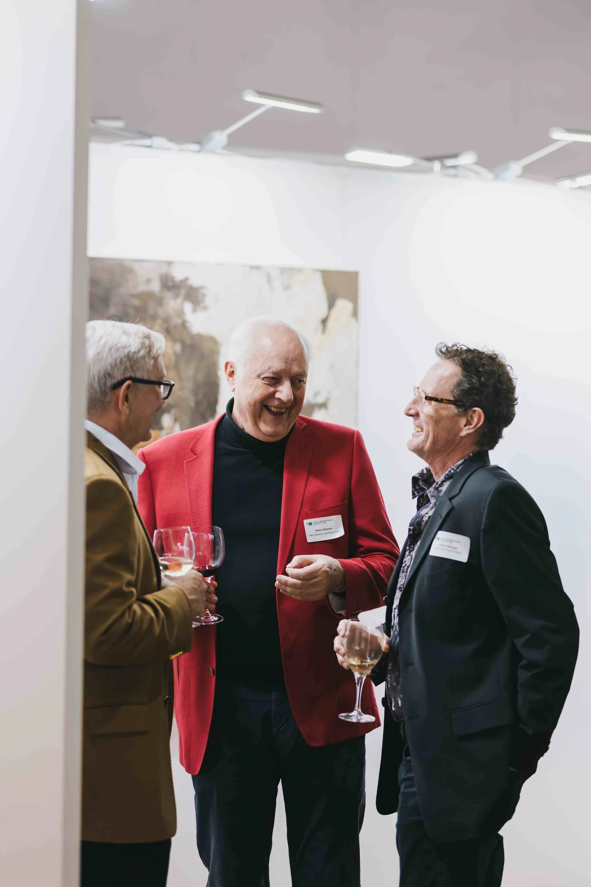 Guests socialising with drinks at an exhibition opening in the Wilkinson Gallery at Claremont Showground.