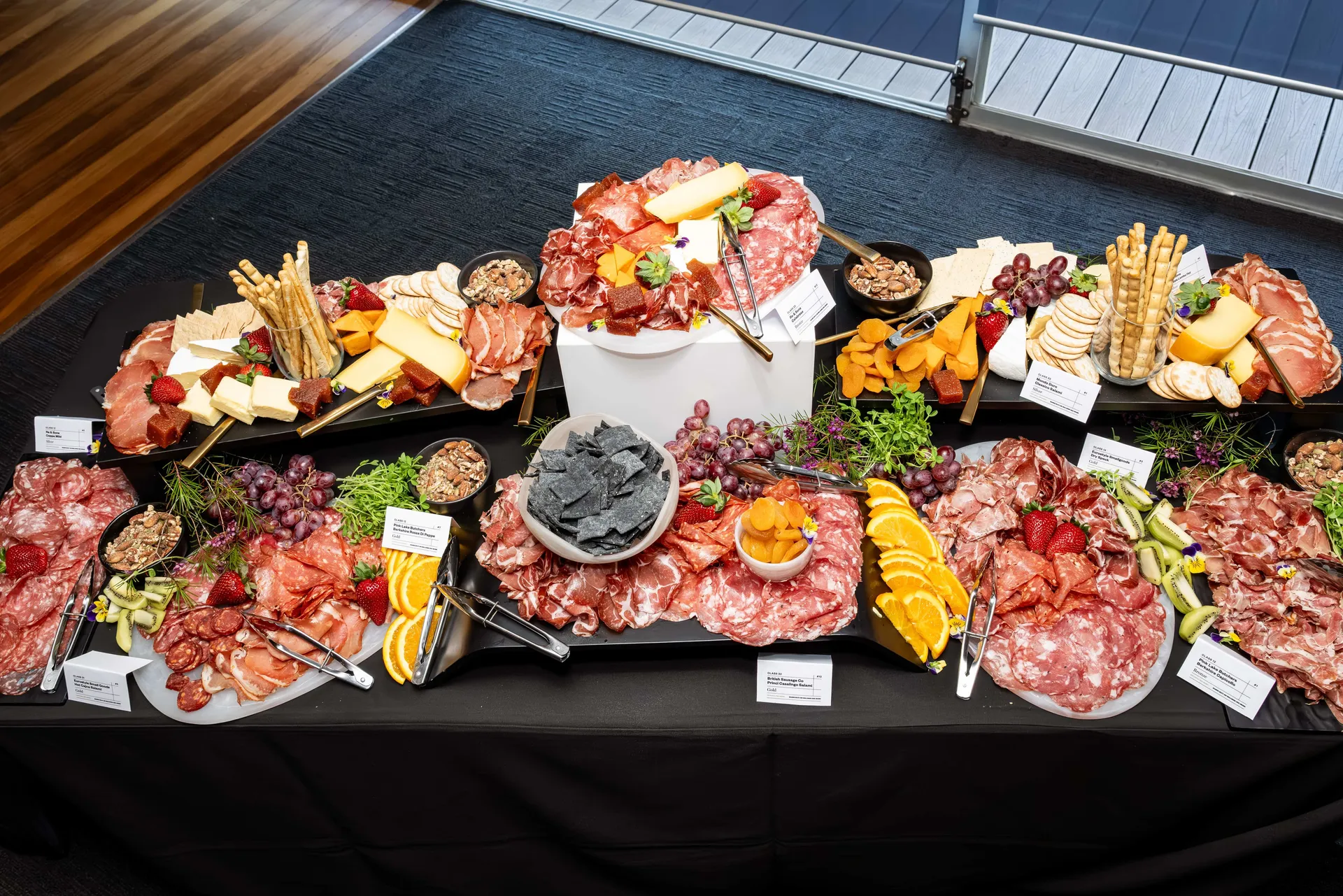 Selection of charcuterie boards with cured meats, cheeses, fruit and crackers displayed for judging at the Perth Royal Food Awards.