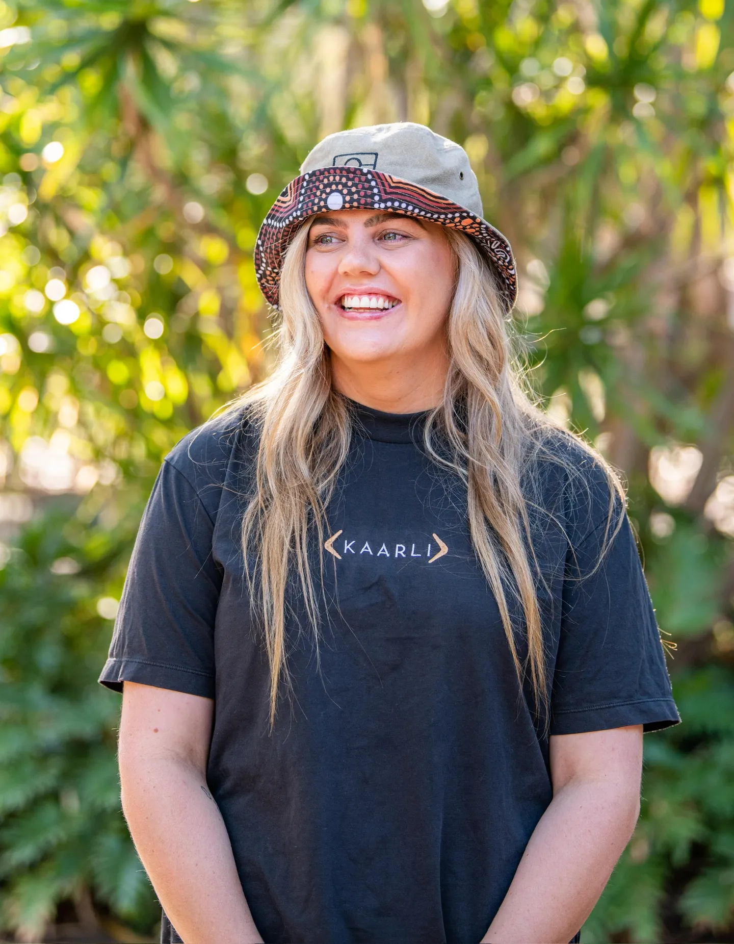 Women wearing Aboriginal artists patterned bucket hats