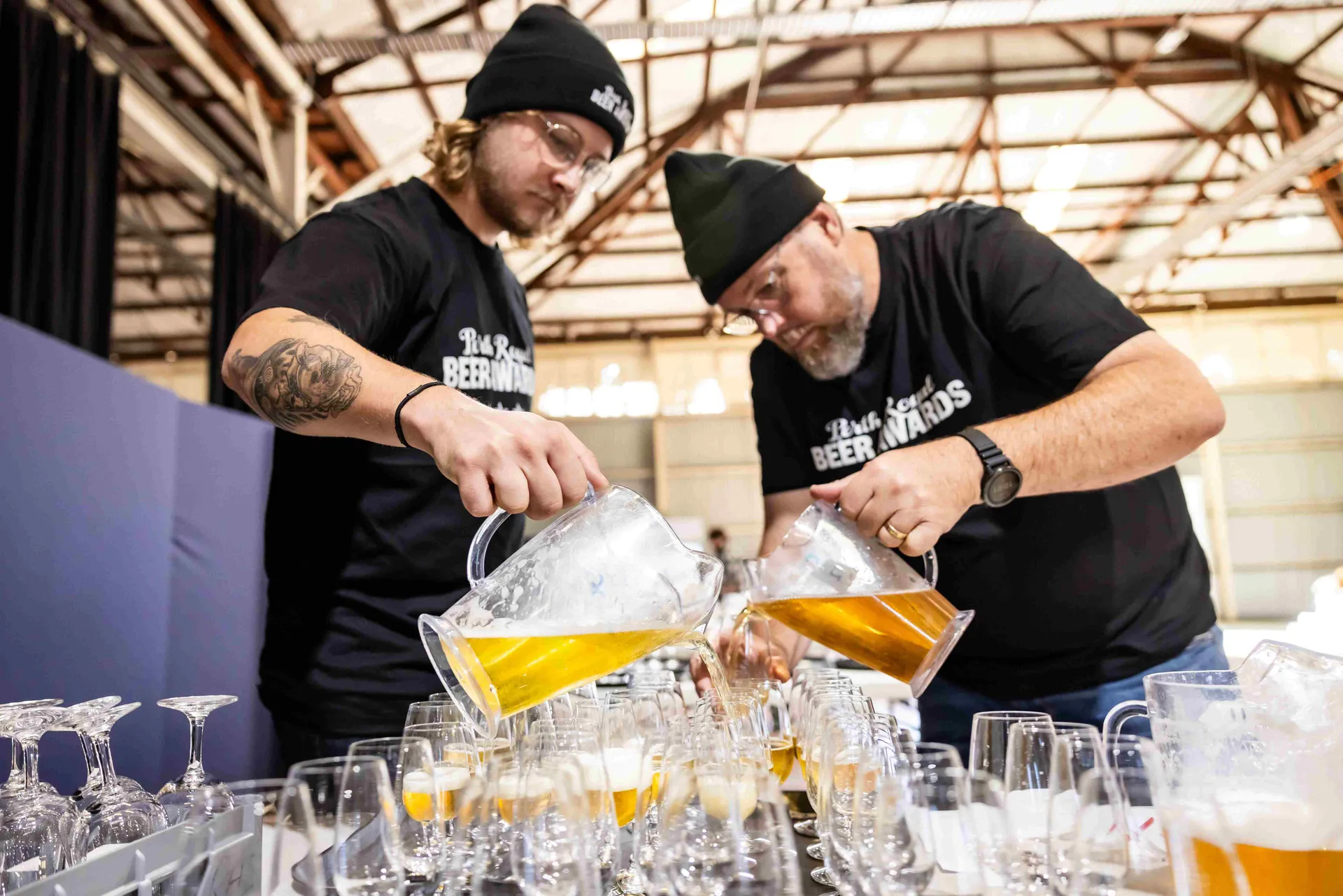 Staff pouring beer samples for judging at the Perth Royal Food Awards.