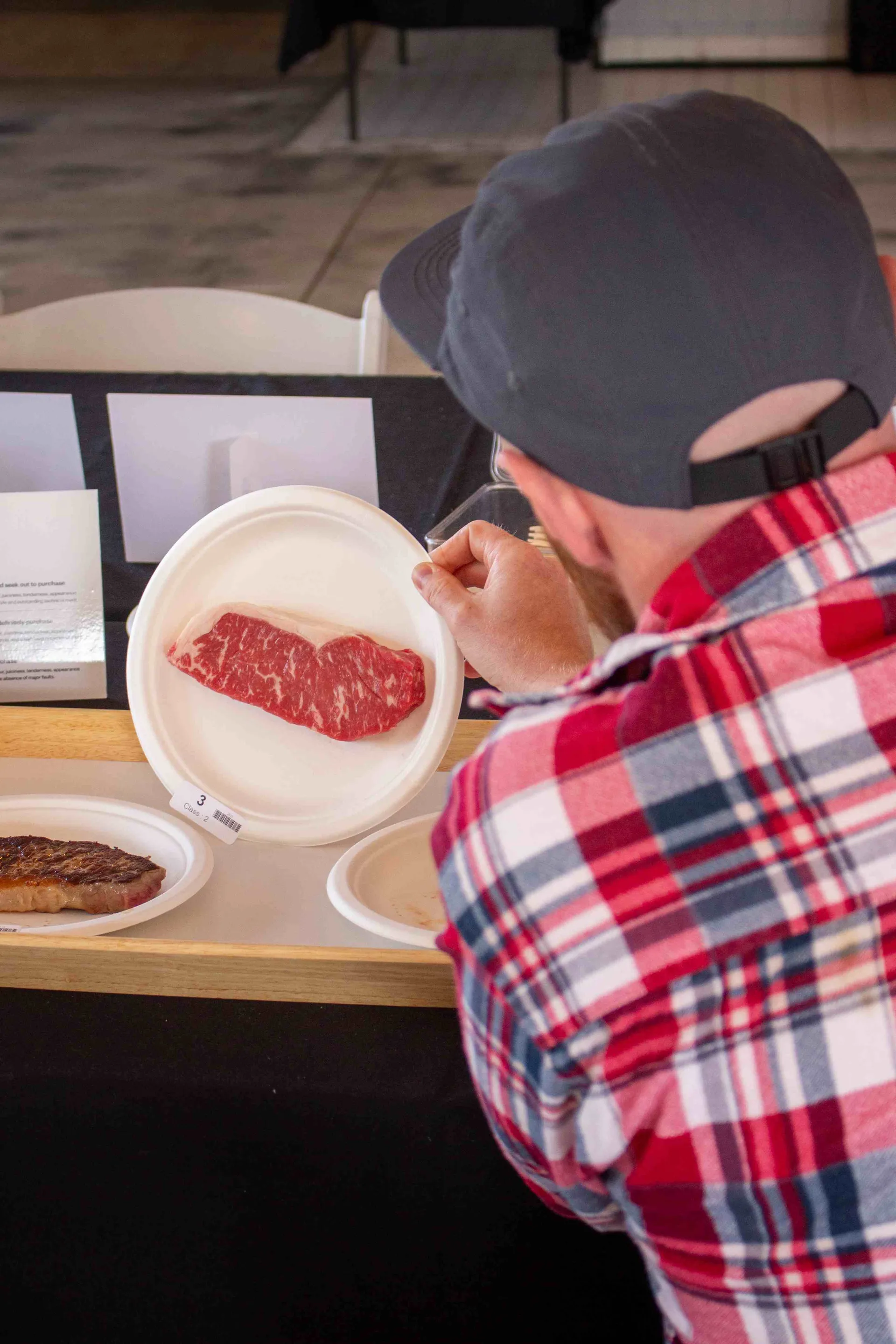 Judge inspecting a steak at the Perth Royal Food Awards.