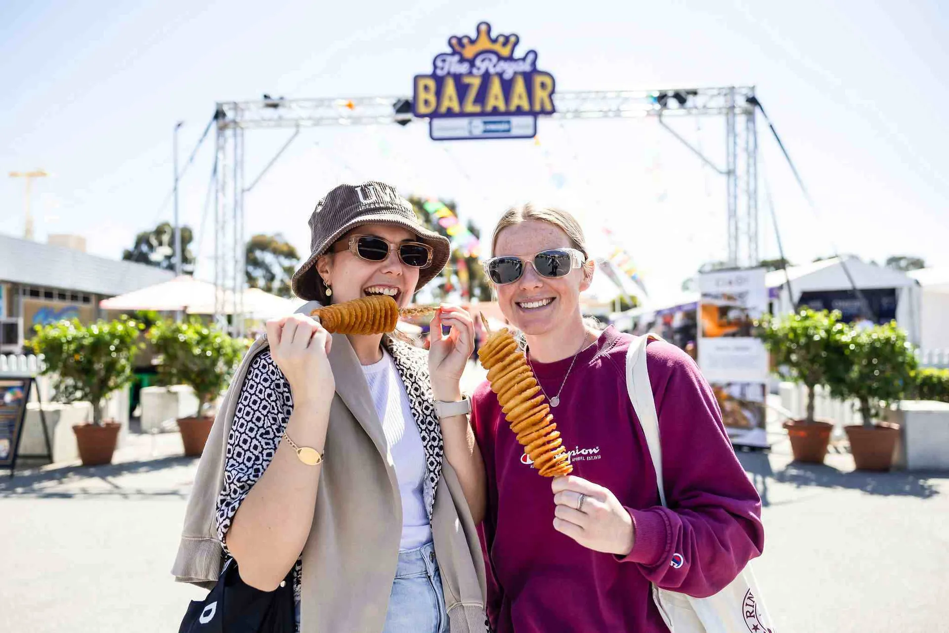 Rows of wine bottles lined up for judging at the Perth Royal Food Awards, with attendees tasting and reviewing entries in the background.