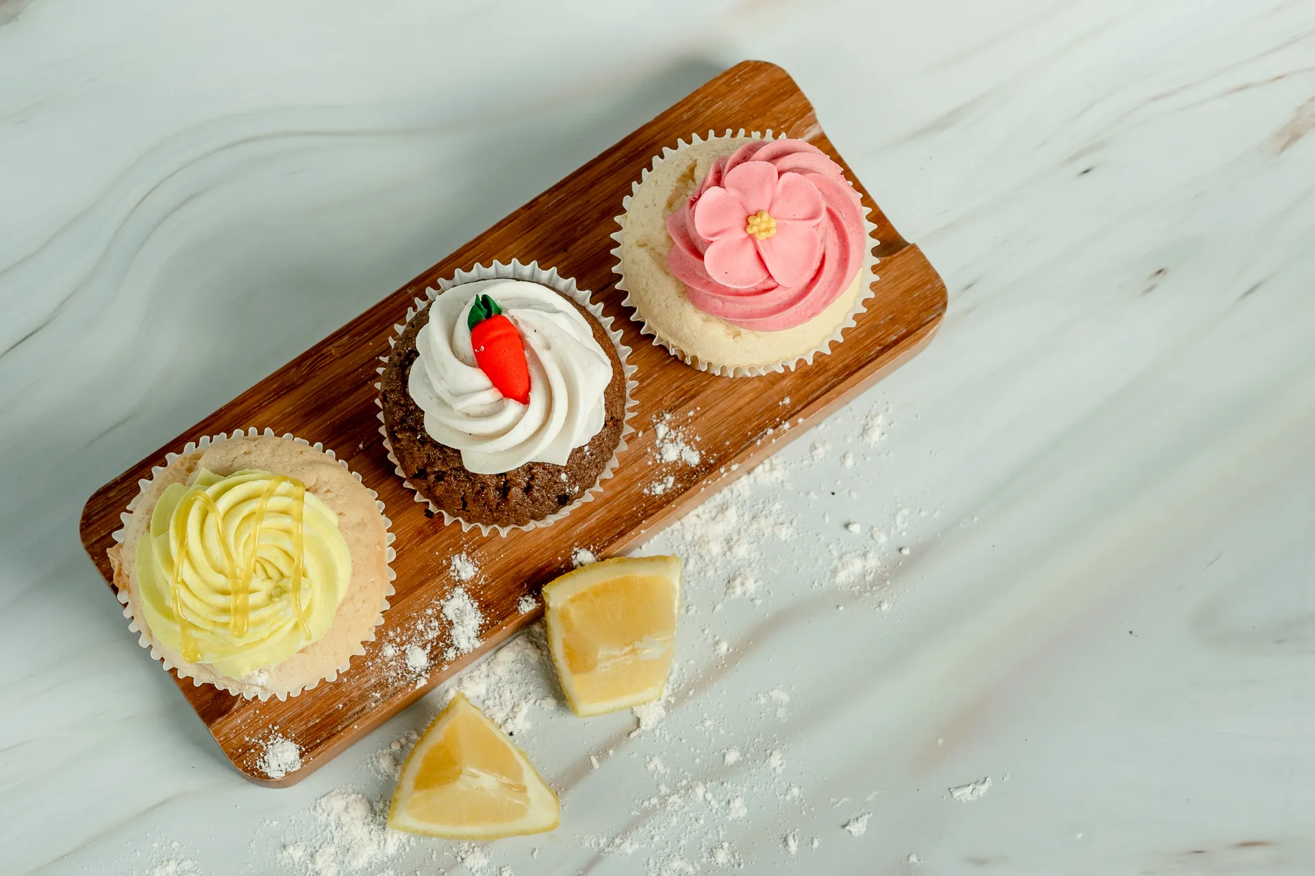 An assortment of carrot, flower and lemon cupcakes 