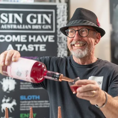 guy smiling while pouring gin