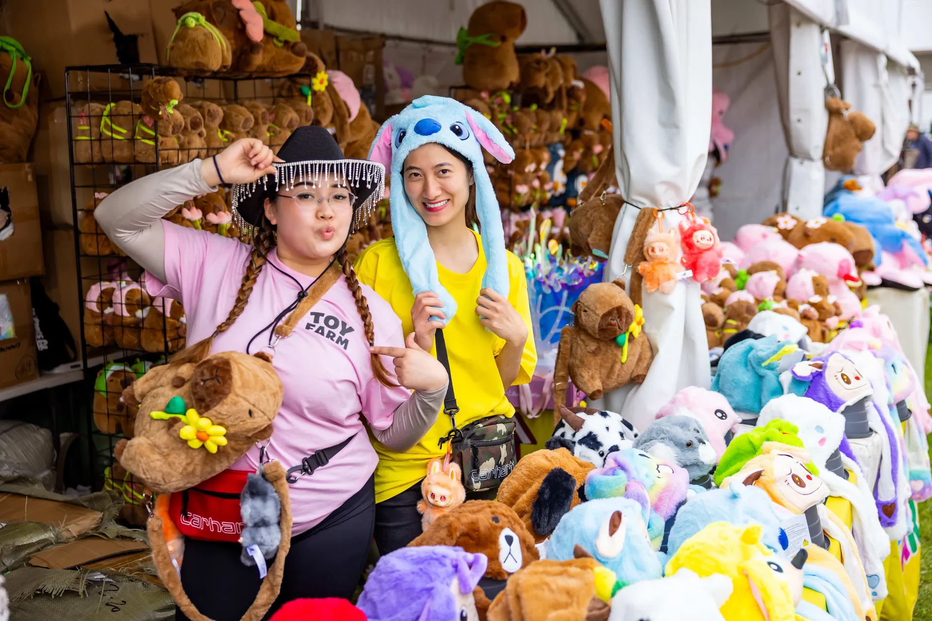 Showbag stall filled with colourful plush toys and prizes at the Perth Royal Show, with visitors browsing the display.