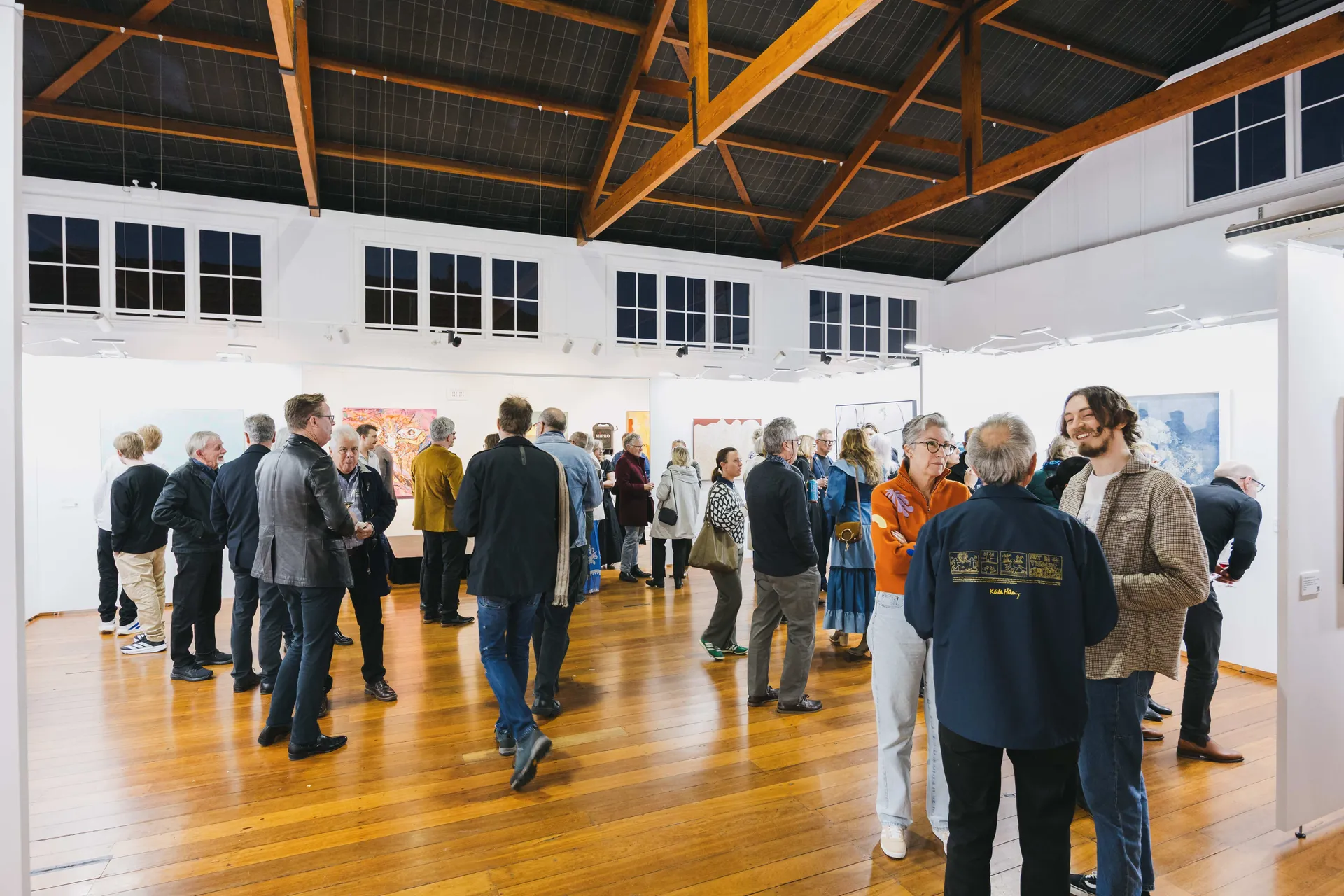 Visitors viewing artwork inside a gallery space at Claremont Showground