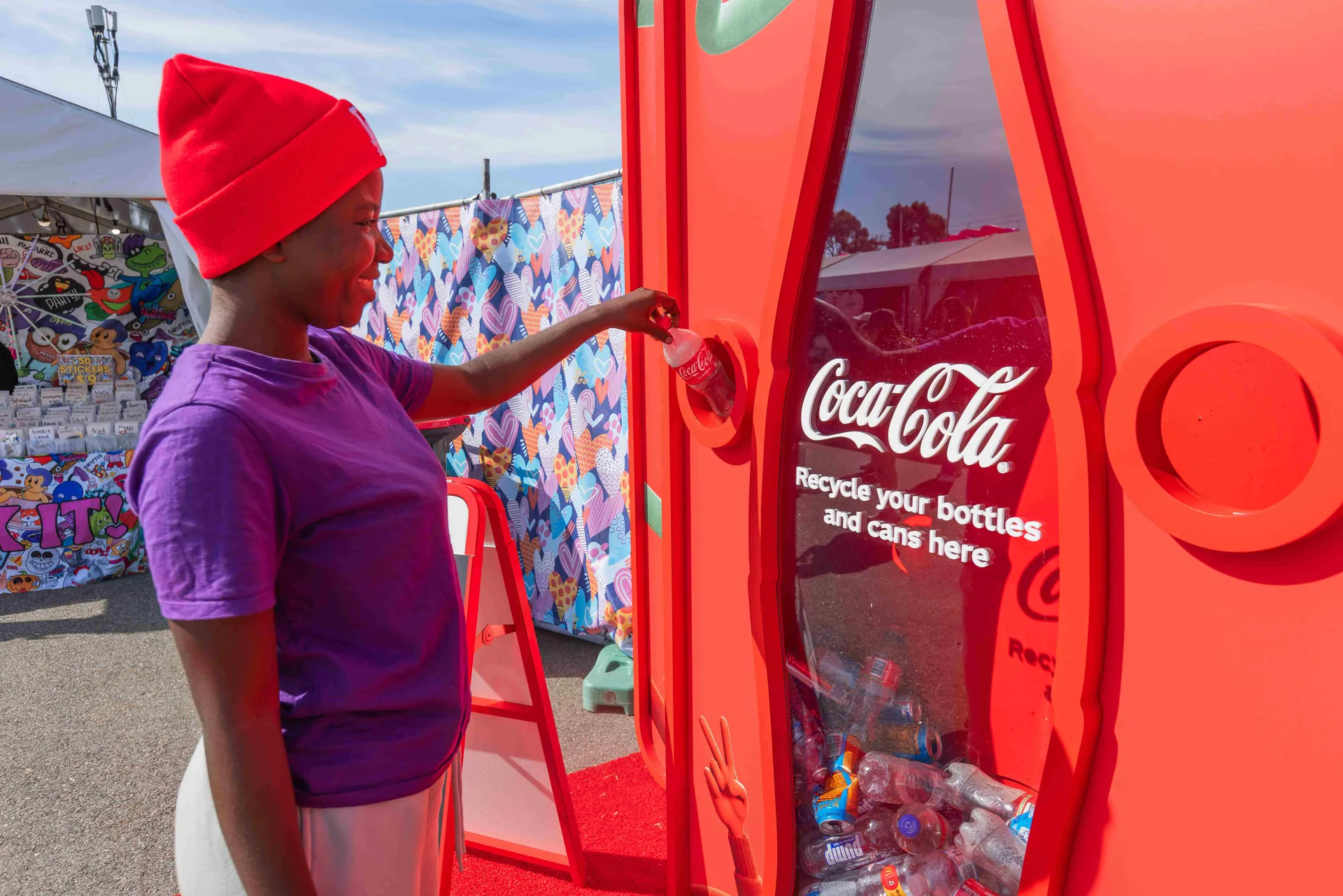 A visitor recycling a drink can at an interactive Coca-Cola recycling station at the Perth Royal Show.