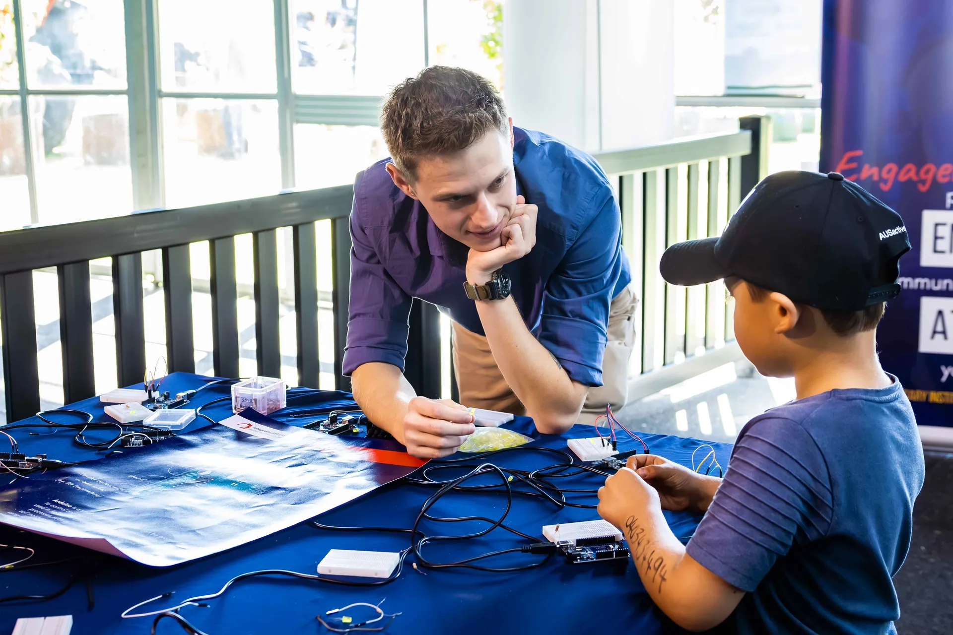 Child learning about agicultural at a hands-on exhibit.
