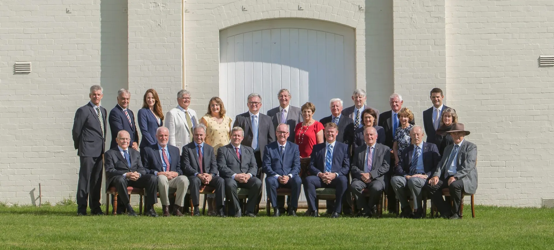 Group portrait of RASWA council members seated and standing outdoors.
