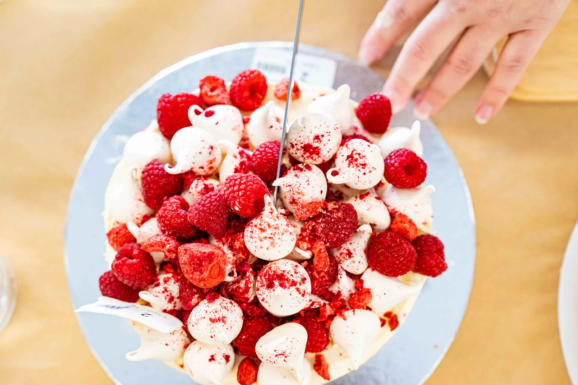 A beautifully decorated dessert topped with meringue and fresh raspberries, presented for judging at the Perth Royal Food Awards.