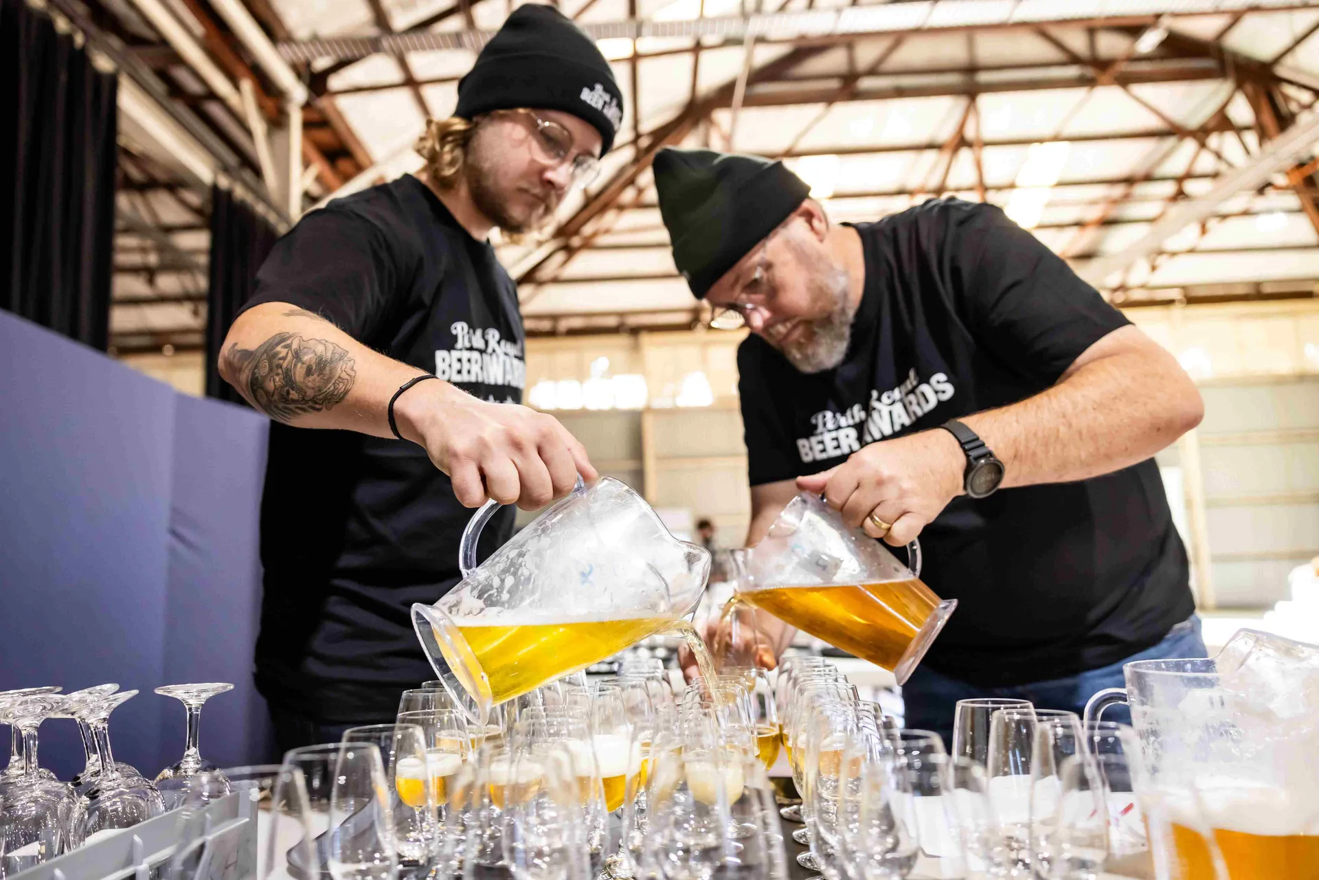 Staff pouring beer samples for judging at the Perth Royal Food Awards.