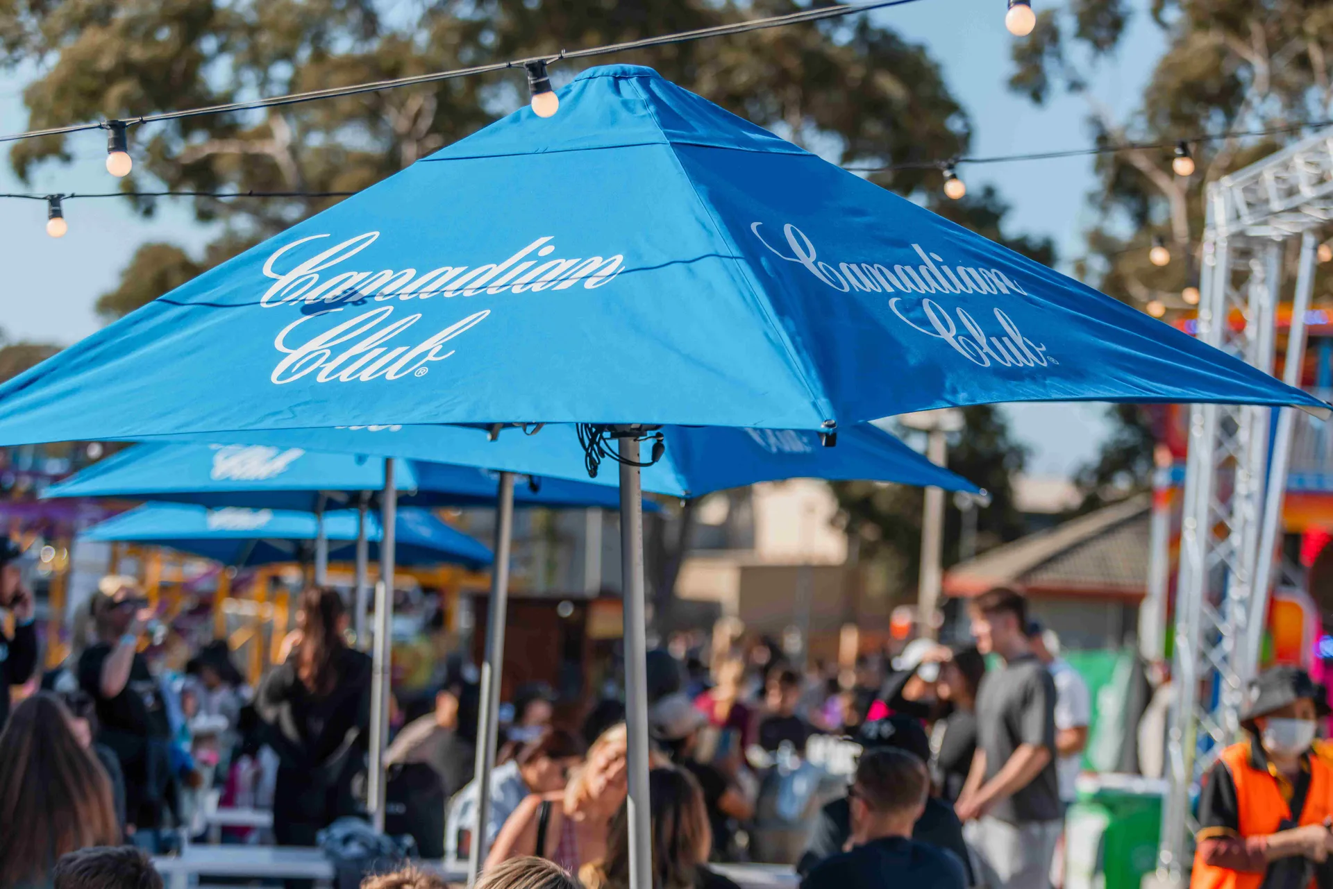 Canadian Club umbrellas shading a busy outdoor seating area at the Perth Royal Show.