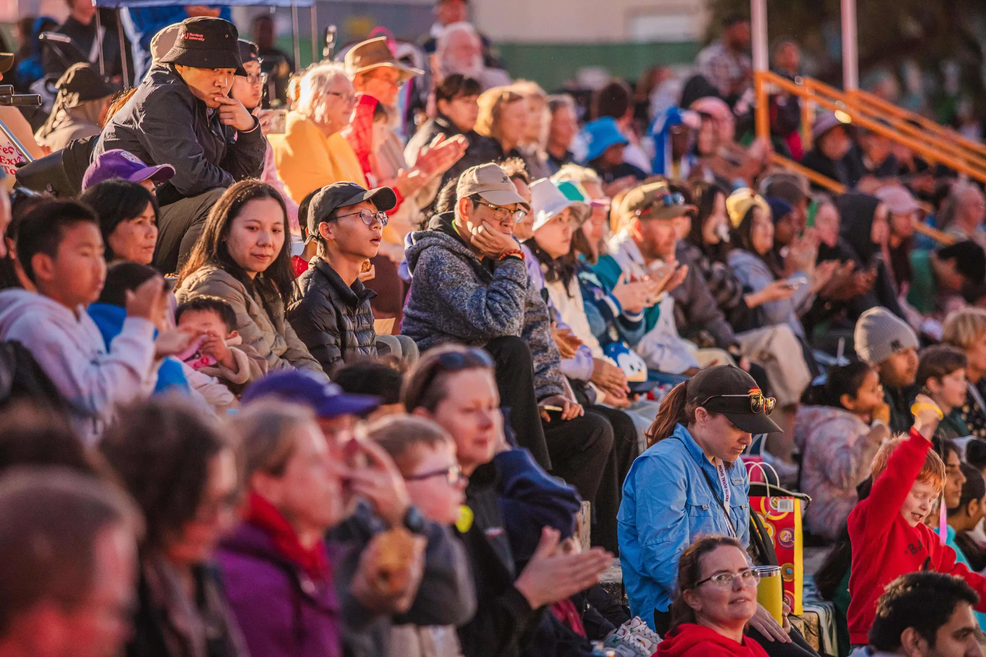 Crowd seated in grandstands watching a live event at Claremont Showground