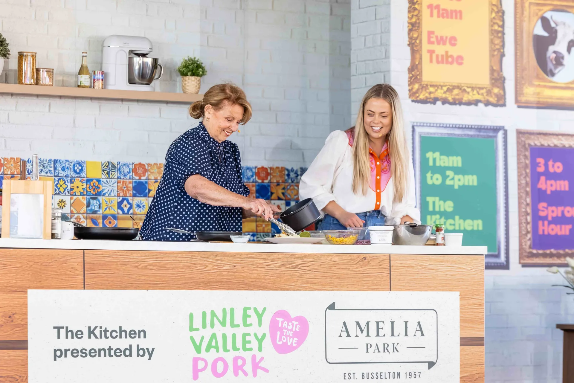 A live cooking demonstration at the Perth Royal Show, with presenters preparing a dish on stage for the audience.